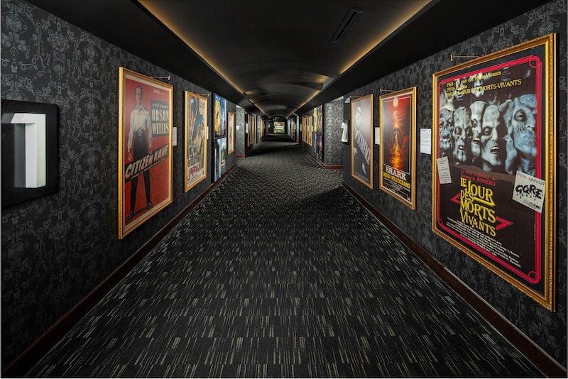 Movie-posters-are-displayed-in-the-theaters-hallway-with-an-accompanying-description-of-the-films-connection-to-Florida.jpg