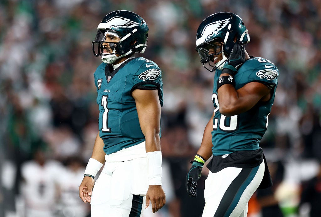 Jalen Hurts #1 and Saquon Barkley #26 of the Philadelphia Eagles walk off the field against the Atlanta Falcons during the first quarter in the game at Lincoln Financial Field on September 16, 2024 in Philadelphia, Pennsylvania.