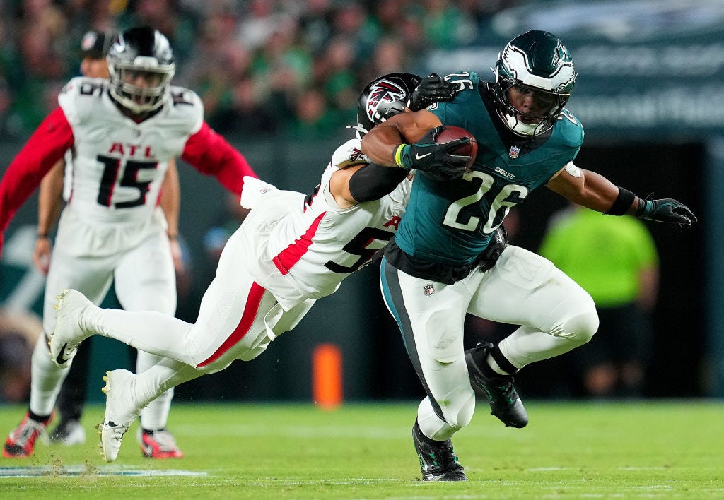 Saquon Barkley #26 of the Philadelphia Eagles runs with the ball against Kaden Elliss #55 of the Atlanta Falcons during the third quarter in the game at Lincoln Financial Field on September 16, 2024 in Philadelphia, Pennsylvania.