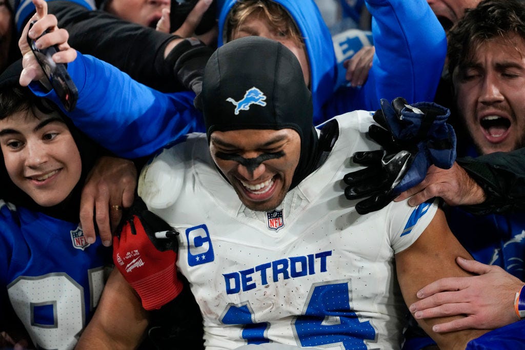 Amon-Ra St. Brown #14 of the Detroit Lions celebrates with fans in the stands after beating the Green Bay Packers 24-14 at Lambeau Field on November 03, 2024 in Green Bay, Wisconsin. 